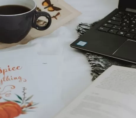 Book blogger set up with computer book and coffee